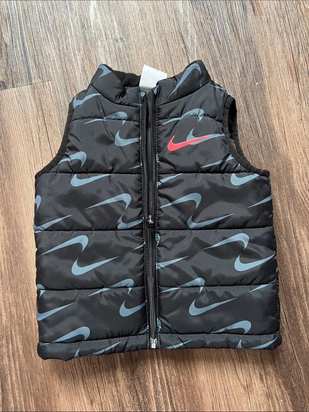 Nike Black Puffer Vest with Blue Swoosh Print and Red Logo